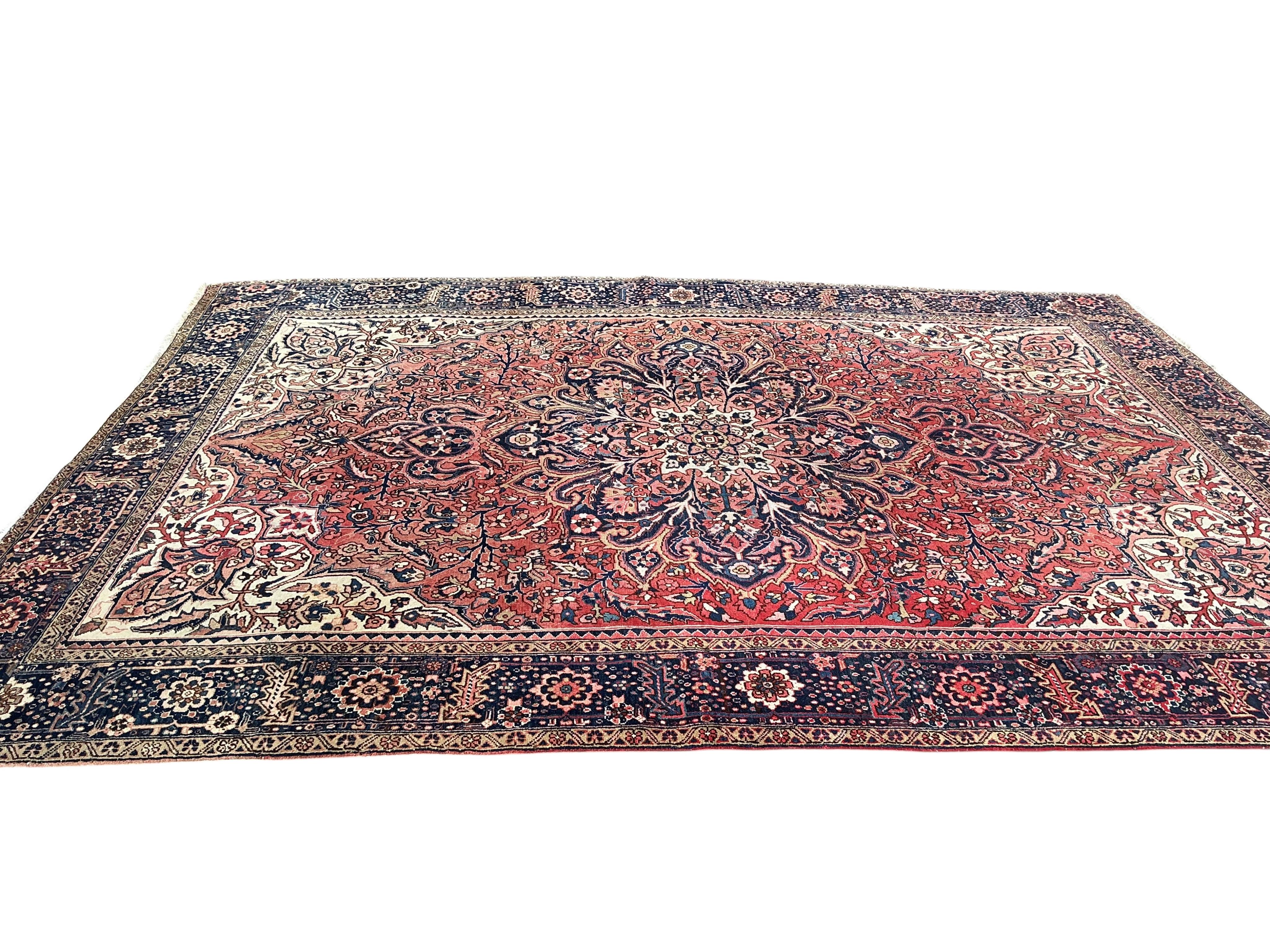 A Heriz red ground carpet, 295 x 270cm